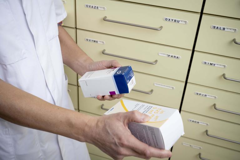 Pharmacist choosing between two medications